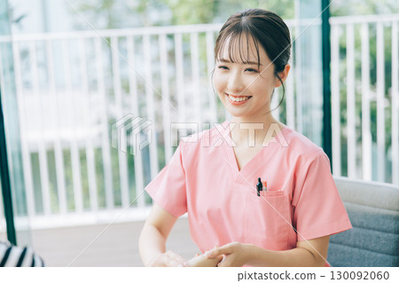 Female nurse taking a pulse Female nurse taking a pulse 130092060