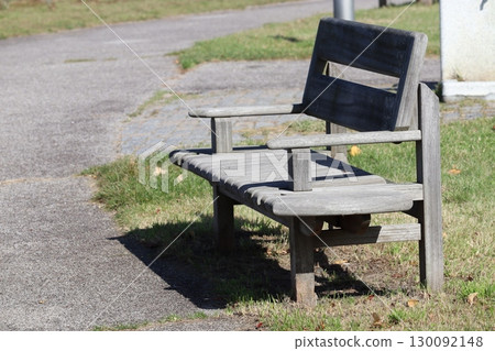 Wooden bench placed on the lawn 130092148