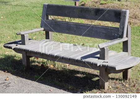 Wooden bench placed on the lawn Wooden bench placed on the lawn 130092149