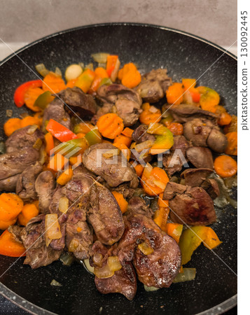 Chicken liver frying in pan with carrots, onions, and peppers Chicken liver frying in pan with carrots, onions, and peppers 130092445
