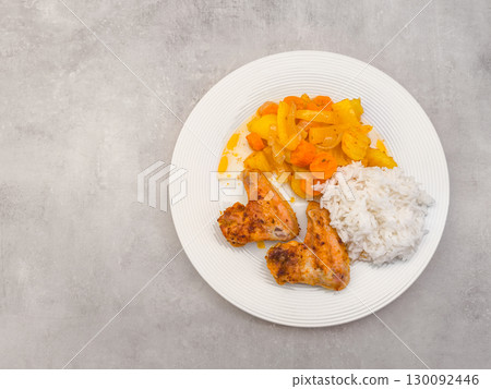 Delicious roasted chicken wings served with rice and steamed vegetables, copy space 130092446