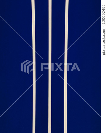 Three vertical beige stripes on dark blue background creating modern and minimalist pattern Three vertical beige stripes on dark blue background creating modern and minimalist pattern 130092493
