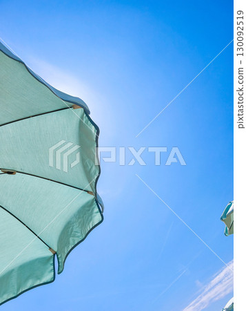 Beach umbrella protecting from sun on clear sky in lignano sabbiadoro 130092519