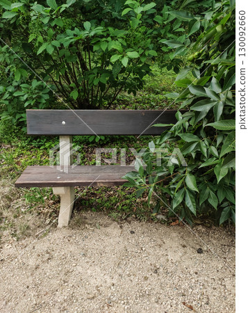 Empty bench inviting rest in a lush green park in pruhonice, czech republic 130092660