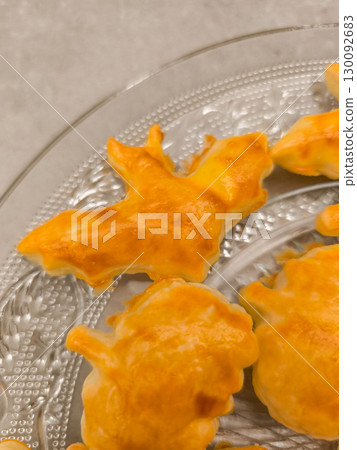 Halloween bat cookies resting on elegant glass platter Halloween bat cookies resting on elegant glass platter 130092683