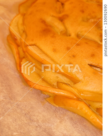 Close up of freshly baked apple cake on baking paper 130092690