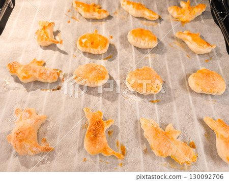 Halloween puff pastry cookies baking on oven tray 130092706
