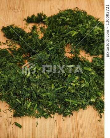 Freshly chopped dill resting on wooden cutting board Freshly chopped dill resting on wooden cutting board 130092721