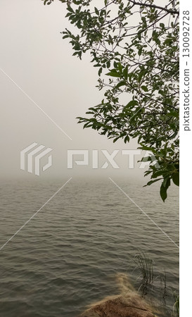 Fog covering strbske pleso lake in the high tatras mountains, slovakia 130092728
