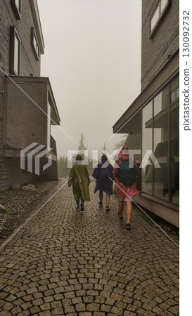 Hikers walking in raincoats at strbske pleso, high tatras, slovakia 130092732