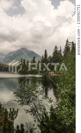 Strbske pleso lake reflecting majestic mountain under cloudy sky in high tatras, slovakia 130092751