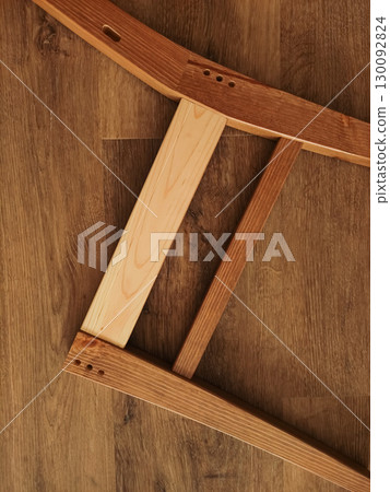 Wooden furniture parts lying on laminate floor in prague Wooden furniture parts lying on laminate floor in prague 130092824