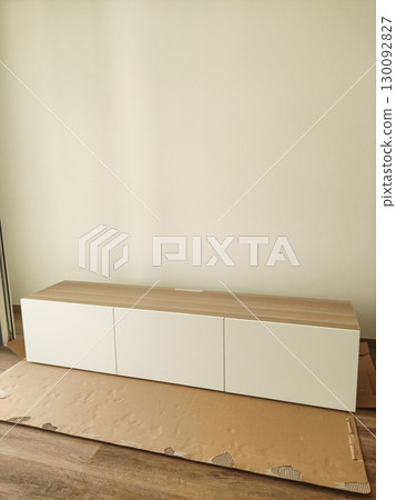 Modern tv stand being assembled in a minimalist living room Modern tv stand being assembled in a minimalist living room 130092827