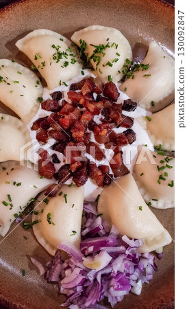 Traditional slovak dumplings with bacon, sour cream, and onion in high tatras 130092847