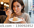 A Japanese woman eating Mont Blanc with relish 130092852