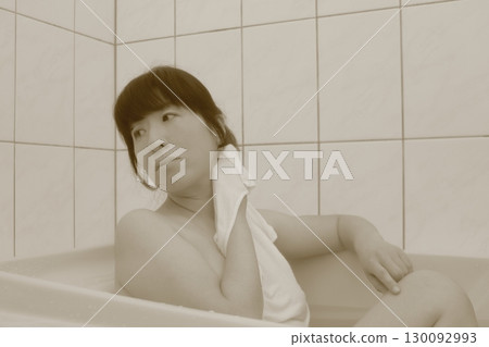 A young woman taking a bath A young woman taking a bath 130092993
