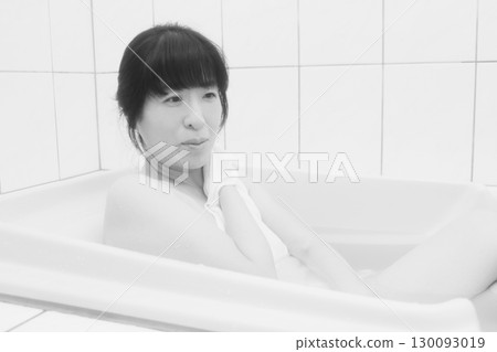 A young woman taking a bath A young woman taking a bath 130093019