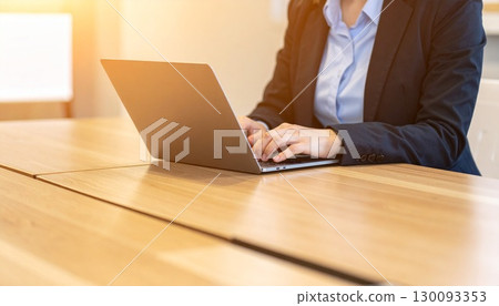 Woman working on a laptop Woman working on a laptop 130093353