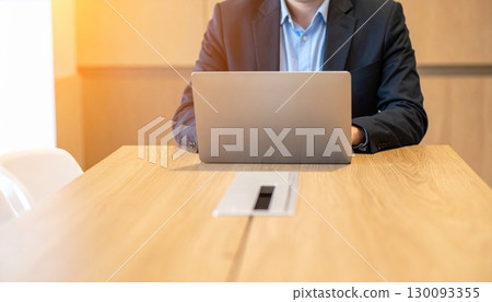 A man who works on a personal computer 130093355