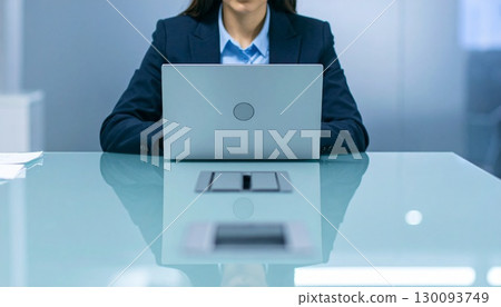 Businessman working at a computer in a conference room 130093749