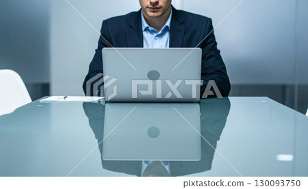 Businessman working at a computer in a conference room 130093750