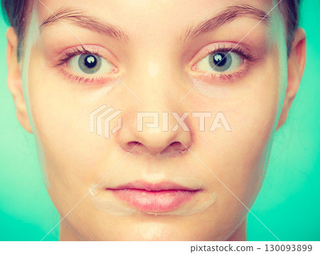 Woman in facial peel off mask. Woman in facial peel off mask. 130093899
