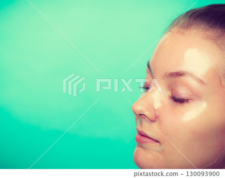 Close up woman in facial peel off mask. Close up woman in facial peel off mask. 130093900