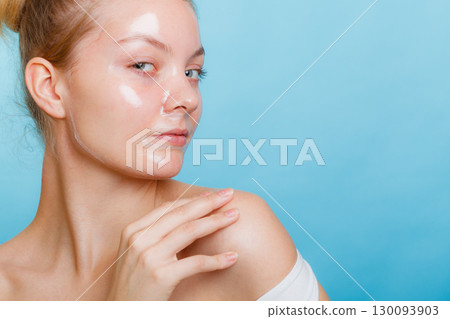 Woman in facial peel off mask. Woman in facial peel off mask. 130093903