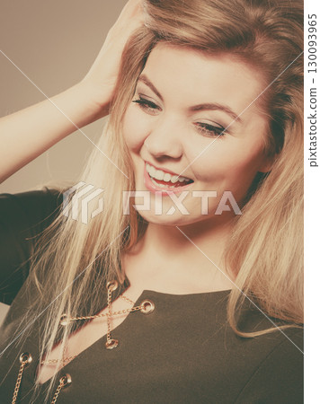 Attractive blonde woman wearing tight green khaki top 130093965