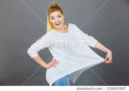 Woman wearing too big jumper 130093997