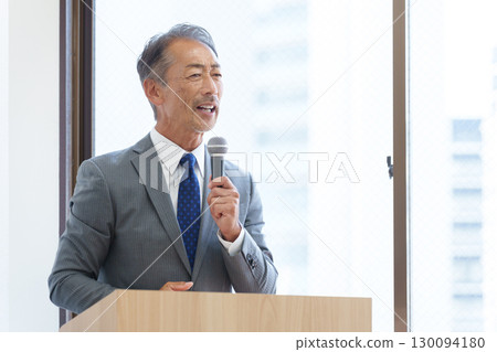 Senior businessman giving a presentation 130094180