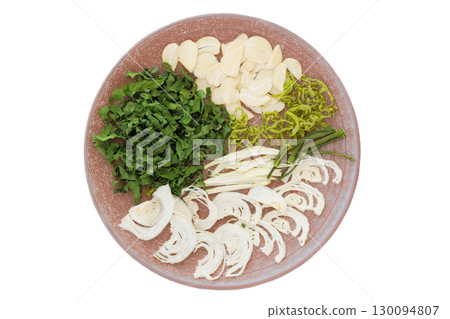 Top view. Freeze-dried food for travel. Homemade preparation. Dried garlic, onion and parsley on a ceramic plate isolated on a white background. 130094807