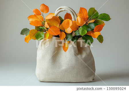 Reusable shopping bag made of fabric with a branches with yellow leaves on a white background. 130095024
