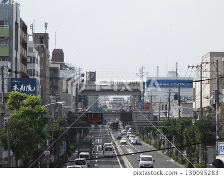 Under a cloudy sky, a main street overlaid with the Tokaido Shinkansen viaduct Under a cloudy sky, a main street overlaid with the Tokaido Shinkansen viaduct 130095283