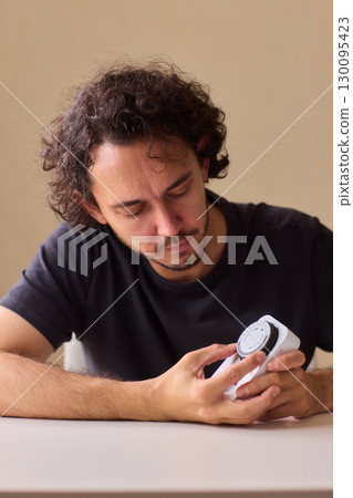 Hands Carefully Connecting a Plug to a Power Strip for Convenient Charging Needs 130095423