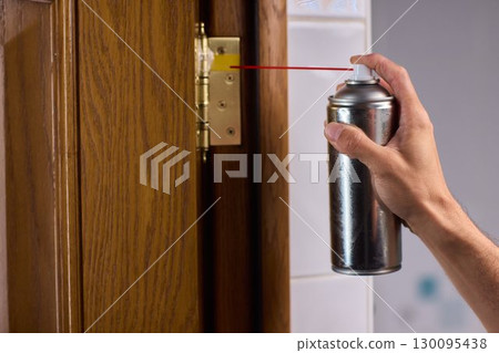 Lubricating a door hinge is extremely essential for ensuring smooth operation in daily use Lubricating a door hinge is extremely essential for ensuring smooth operation in daily use 130095438
