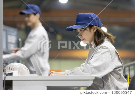 Male and female workers working in a factory 130095547