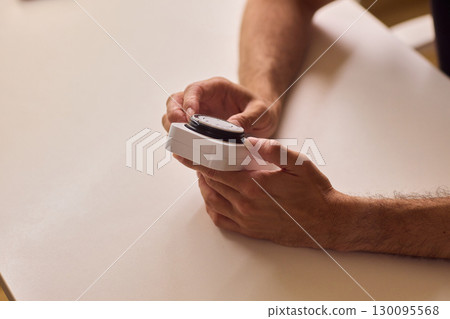 Hands Interacting Carefully with a Modern Device Component in a Tech Environment 130095568