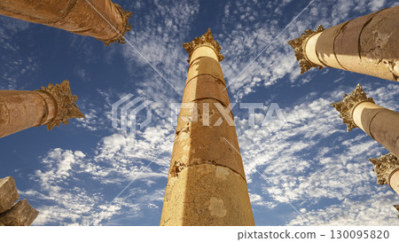 Roman Columns in the Jordanian city of Jerash (Gerasa of Antiquity), capital and largest city of Jerash Governorate, Jordan. Against the background of a beautiful sky with clouds Roman Columns in the Jordanian city of Jerash (Gerasa of Antiquity), capital and largest city of Jerash Governorate, Jordan. Against the background of a beautiful sky with clouds 130095820