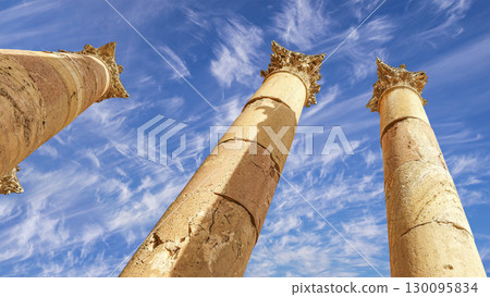 Roman Columns in the Jordanian city of Jerash (Gerasa of Antiquity), capital and largest city of Jerash Governorate, Jordan. Against the background of a beautiful sky with clouds 130095834