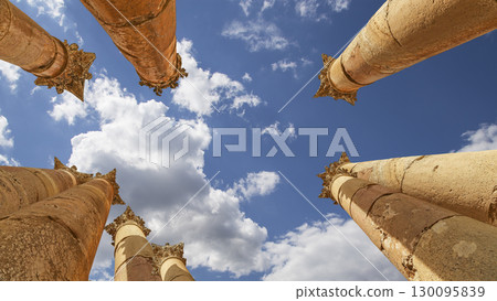 Roman Columns in the Jordanian city of Jerash (Gerasa of Antiquity), capital and largest city of Jerash Governorate, Jordan. Against the background of a beautiful sky with clouds 130095839