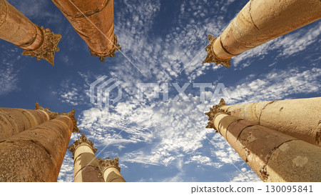 Roman Columns in the Jordanian city of Jerash (Gerasa of Antiquity), capital and largest city of Jerash Governorate, Jordan. Against the background of a beautiful sky with clouds 130095841