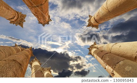 Roman Columns in the Jordanian city of Jerash (Gerasa of Antiquity), capital and largest city of Jerash Governorate, Jordan. Against the background of a beautiful sky with clouds 130095843