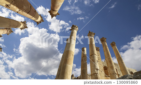 Roman Columns in the Jordanian city of Jerash (Gerasa of Antiquity), capital and largest city of Jerash Governorate, Jordan. Against the background of a beautiful sky with clouds 130095860
