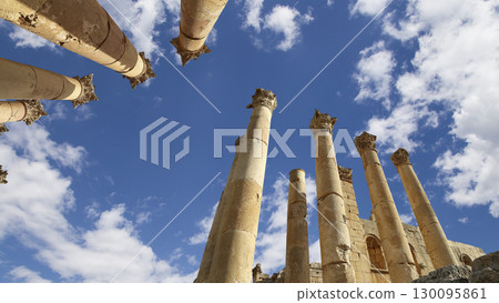 Roman Columns in the Jordanian city of Jerash (Gerasa of Antiquity), capital and largest city of Jerash Governorate, Jordan. Against the background of a beautiful sky with clouds 130095861