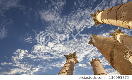 Roman Columns in the Jordanian city of Jerash (Gerasa of Antiquity), capital and largest city of Jerash Governorate, Jordan. Against the background of a beautiful sky with clouds 130095873