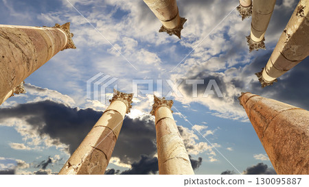 Roman Columns in the Jordanian city of Jerash (Gerasa of Antiquity), capital and largest city of Jerash Governorate, Jordan. Against the background of a beautiful sky with clouds 130095887