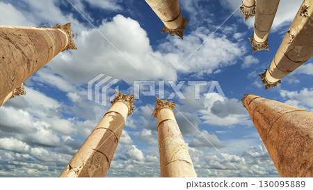 Roman Columns in the Jordanian city of Jerash (Gerasa of Antiquity), capital and largest city of Jerash Governorate, Jordan. Against the background of a beautiful sky with clouds 130095889