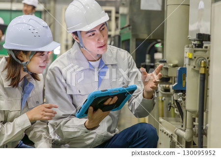 Group of workers working in a factory 130095952