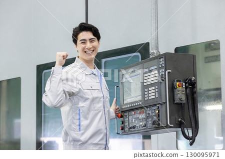Male worker working in front of a factory control panel Male worker working in front of a factory control panel 130095971